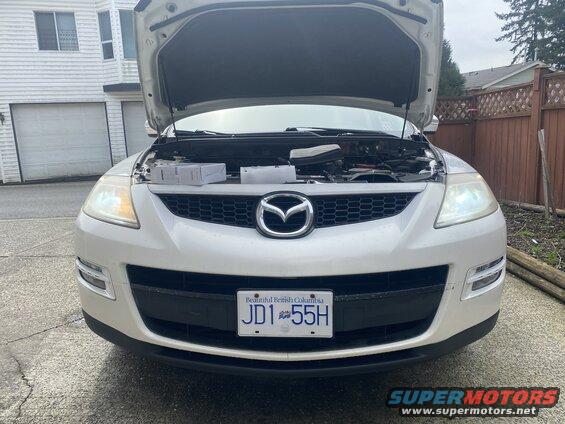 White Mazda CX-9 with hood open, front view, BC license plate JD1 55H