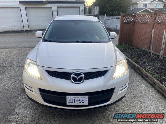 White 2009 Mazda CX-9 front view with headlights on, BC license plate JD1 55H