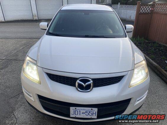 White 2009 Mazda CX-9 front view, headlights on, BC license plate JDT 55H