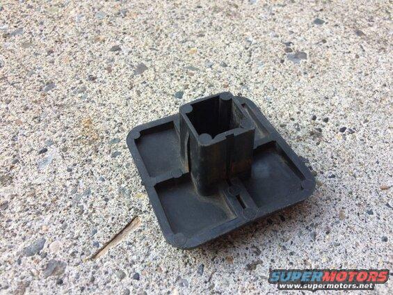 Black plastic hitch receiver cover on concrete