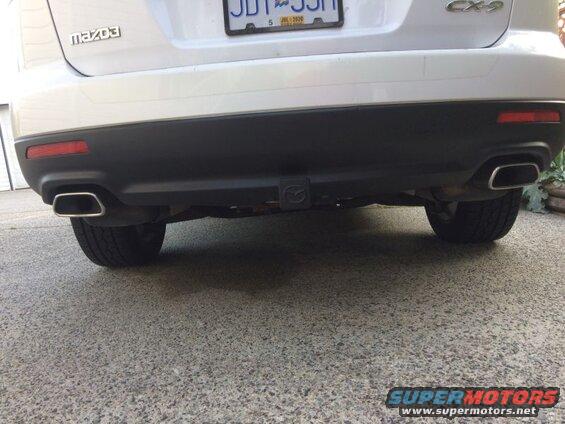 Rear view of a white Mazda CX-9 SUV with dual exhaust and trailer hitch