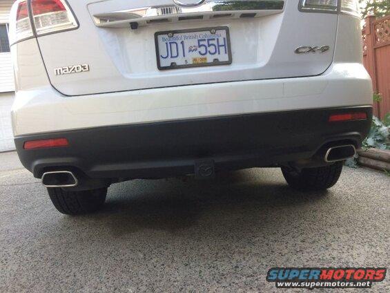 Rear view of a white Mazda CX-9 SUV with dual exhaust and BC license plate JD1-55H.