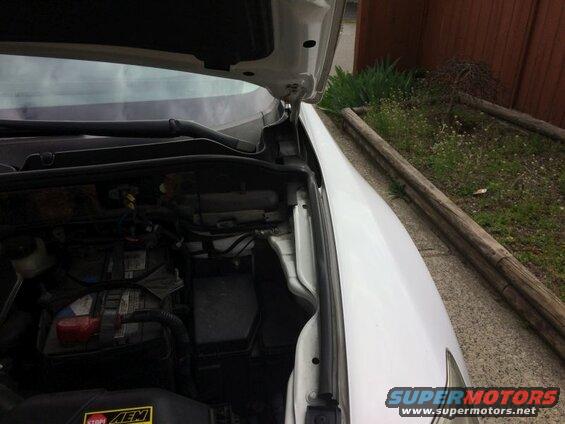 White 2009 Mazda CX-9 engine bay with hood open, parked outdoors.