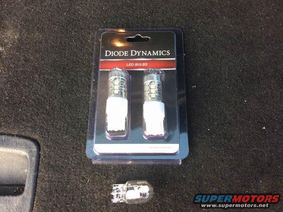 Diode Dynamics LED bulbs package on carpet with one loose bulb.
