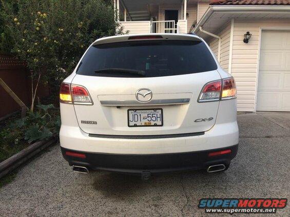 Rear view of a white 2009 Mazda CX-9 SUV with license plate JD1 55H.