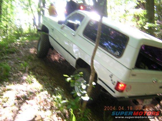 1984 Chevrolet Blazer driving off-road on a wooded trail