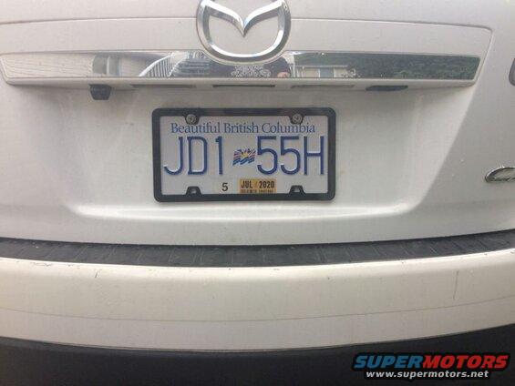 Rear view of a white Mazda CX-9 with license plate JD1 55H, expiring JUL 2020.