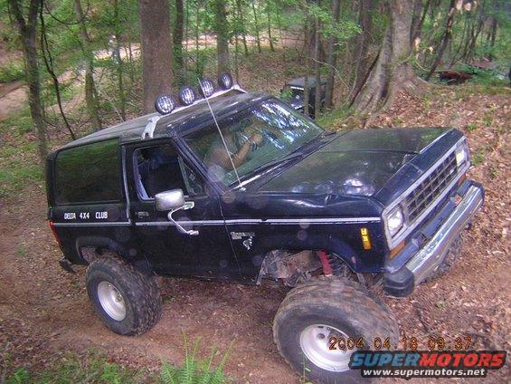 Black SUV with "DELTA 4X4 CLUB" text on door, lifted suspension, and roof-mounted lights