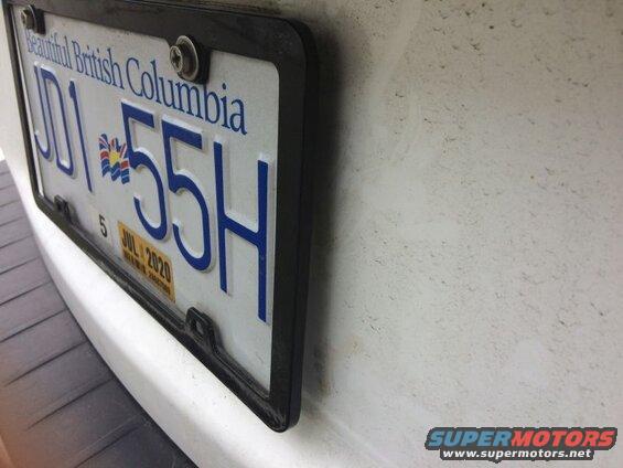 British Columbia license plate JD1 55H on a white vehicle.