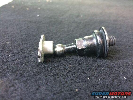 Automotive ball stud with threaded end and flange on dark surface