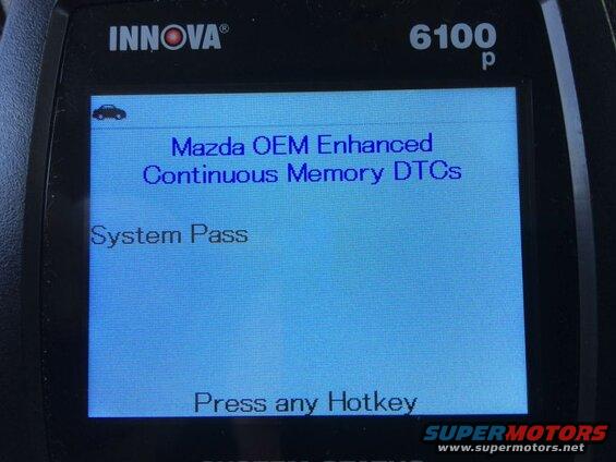 Close-up of an Innova 6100p scan tool screen showing Mazda DTCs and System Pass.