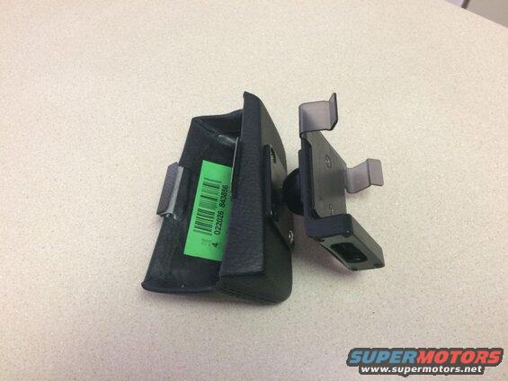 Black leather case with barcode sticker attached to a black phone mount with clear grips.
