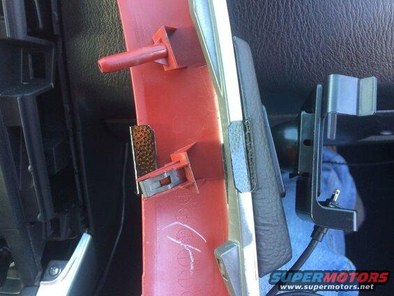 Red interior trim piece with silver accent and black phone mount