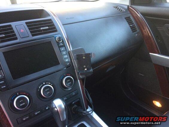 Car dashboard with phone mount and charging cable