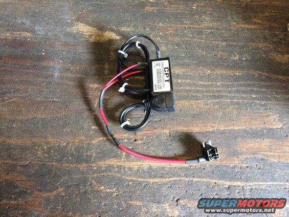 CPT car power DC-DC USB converter with wires on a wooden surface