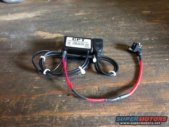 CPT 12V DC-DC USB converter with fused car adapter on wood surface
