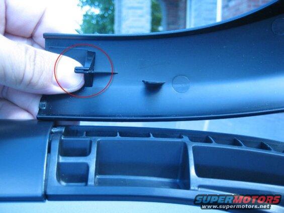 Found this online; shows the tab that holds the roof rail cover in place.