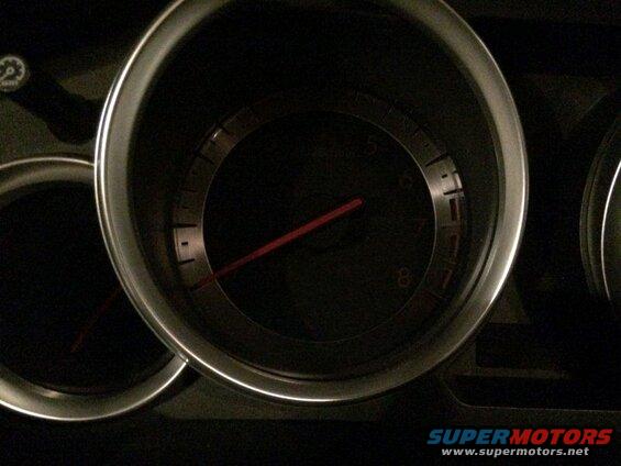 Close-up of car dashboard gauges, one showing RPM between 7 and 8.