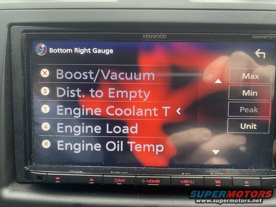 Car stereo screen showing engine gauges and settings menu