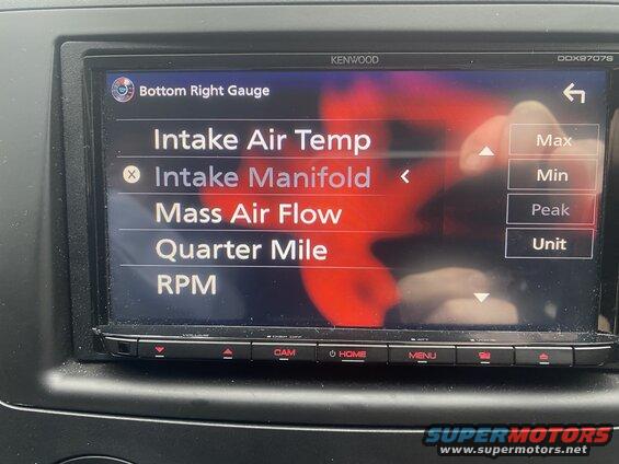 Car infotainment screen showing a list of selectable gauges including Intake Air Temp, Intake Manifold, Mass Air Flow, Quarter Mile, and RPM.