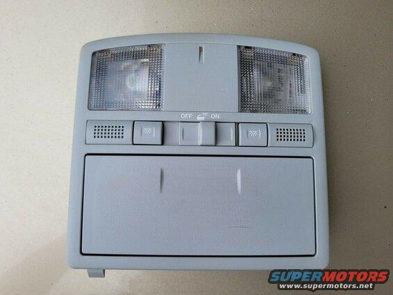 Gray overhead console with lights, buttons, and storage compartment.