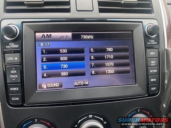 Car infotainment screen showing AM radio presets.