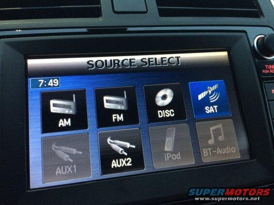 Car infotainment screen showing source select options: AM, FM, Disc, SAT, AUX1, AUX2, iPod, BT-Audio.