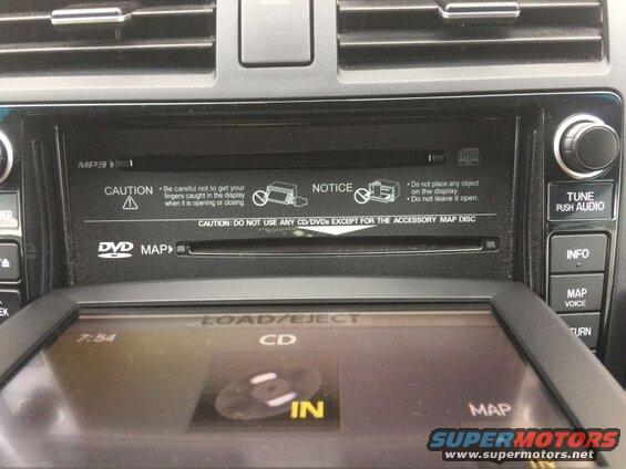 Car infotainment system with CD/DVD player and navigation screen.