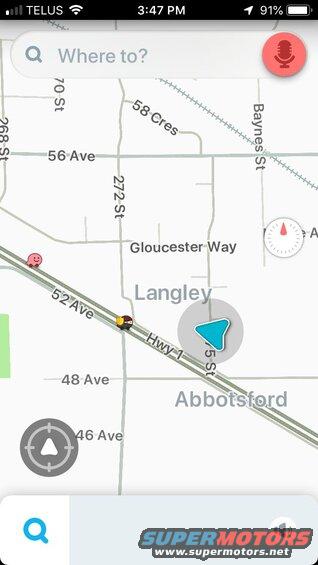 Screenshot of a navigation app map displaying roads, current location, and a search bar.