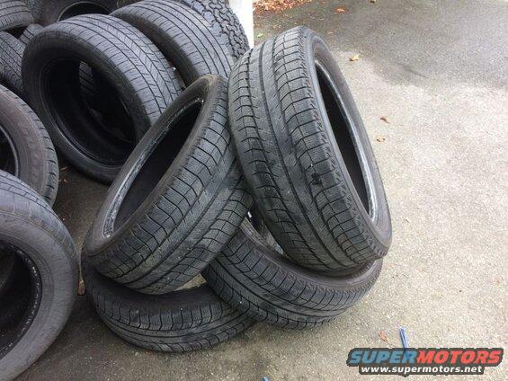Stack of used car tires on pavement
