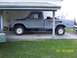 1978 Ford F-150 - This 1978 Ford F-150 pickup truck is seen in side profile, parked under a carport with its hood up.