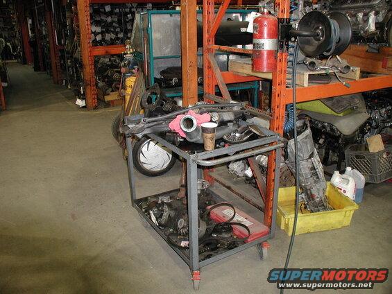 Car parts on a cart in a warehouse.