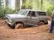 1979 Ford Bronco - This 1979 Ford Bronco is stuck deep in the mud with the driver's door ajar.