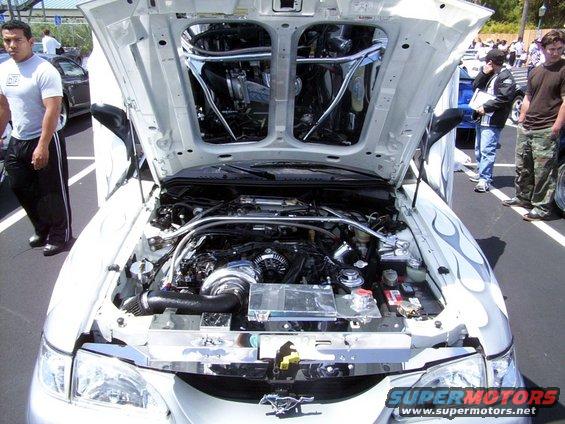 White 2002 Ford Mustang engine bay with custom flames on the fender
