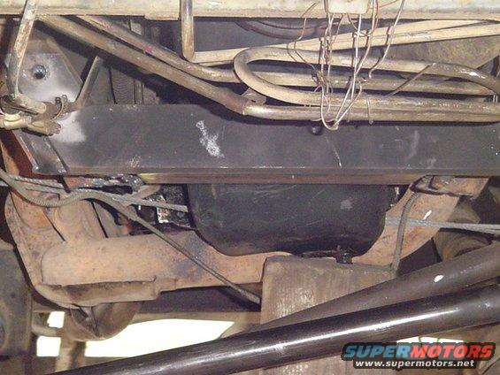 Underside view of vehicle frame, exhaust pipes, and fuel tank
