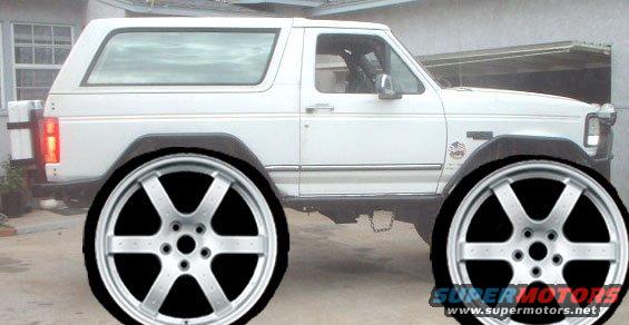 White 1990 Ford Bronco side view with large aftermarket wheels