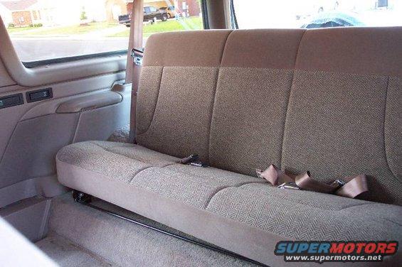 1992 Ford Bronco interior rear bench seat with brown fabric and seatbelts
