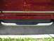 1994 Ford Bronco - Close-up of chrome step bars with black pads on a dark red vehicle.