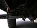 1994 Ford Bronco - Close-up view of the underbody and step bars of a vehicle, with a tire visible on the left.