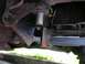 1994 Ford Bronco - Close-up view of the undercarriage, highlighting a chrome step bar attached to the vehicle's frame.