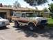 1979 Ford Bronco - A vintage Ford Bronco is parked in a driveway with a house and trees in the background.