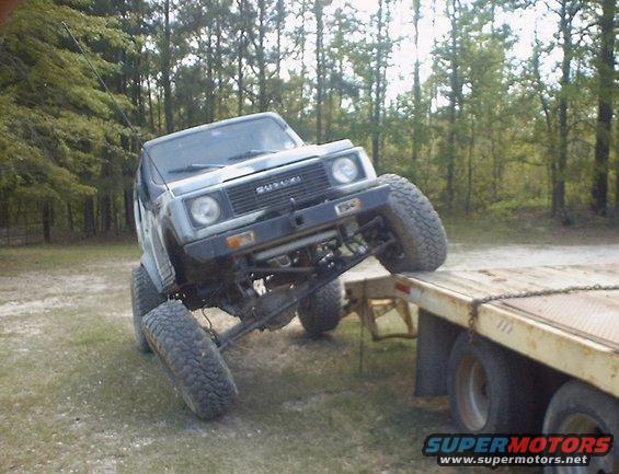 Suzuki Samurai with lifted suspension on a flatbed trailer