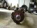 1993 Ford Bronco - Front axle assembly with disc brake and WARN locking hub. Other vehicle parts are in the background.