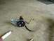 1993 Ford Bronco - A disassembled power steering pump and associated hoses are shown on a garage floor next to a shock absorber.