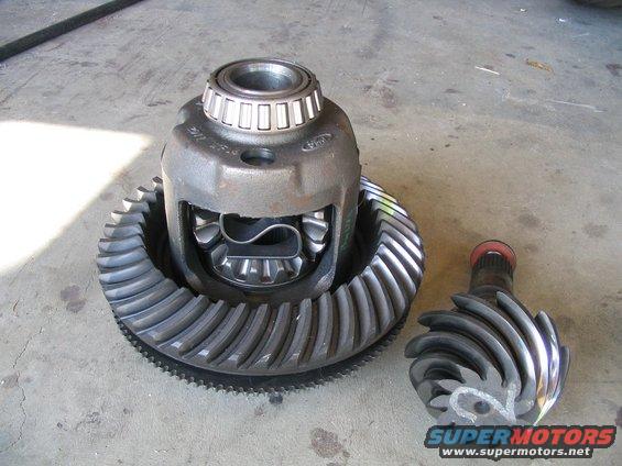 Differential housing with ring gear and pinion gear disassembled on concrete