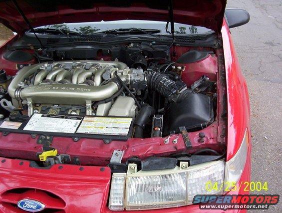 Red 1995 Ford Taurus engine bay with V6 engine
