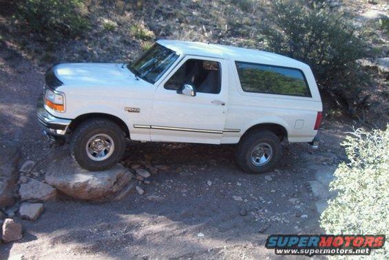 White 1995 Ford Bronco navigating rocky terrain