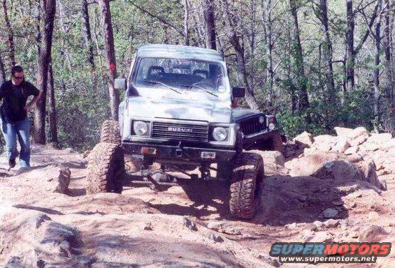 Suzuki Samurai off-roading on a rocky trail, front view