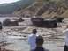 2000 Ford F-450 - Multiple vehicles are stuck in the mud, creating large splashes as they attempt to drive through the mire.