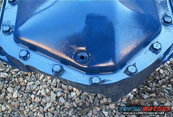 close-up of a blue painted differential axle housing with bolts